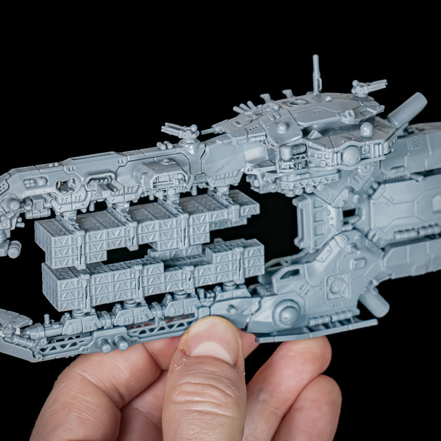 The Opulence spaceship miniature held in a hand
